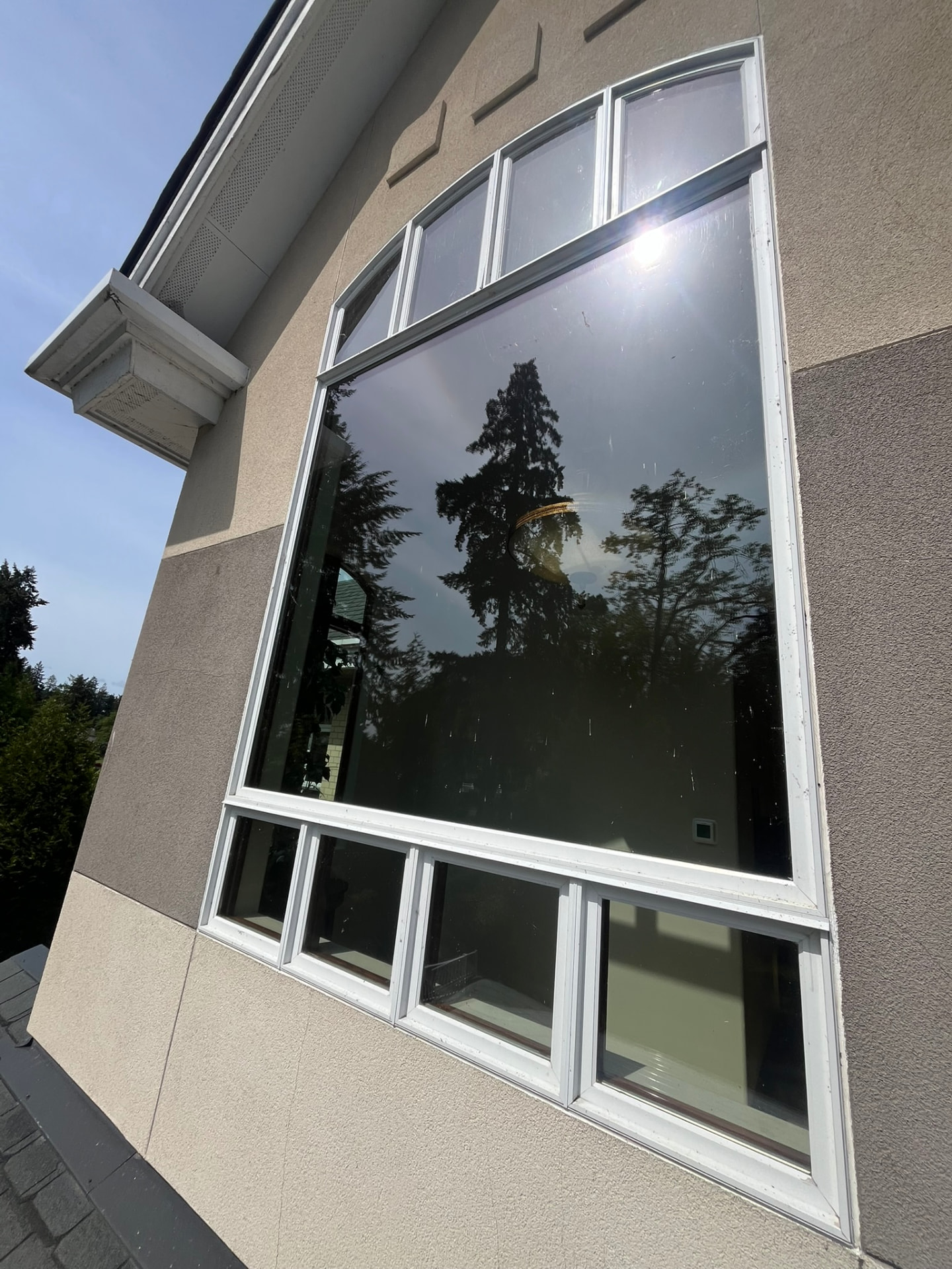 A large exterior window covered in dirt and water spots