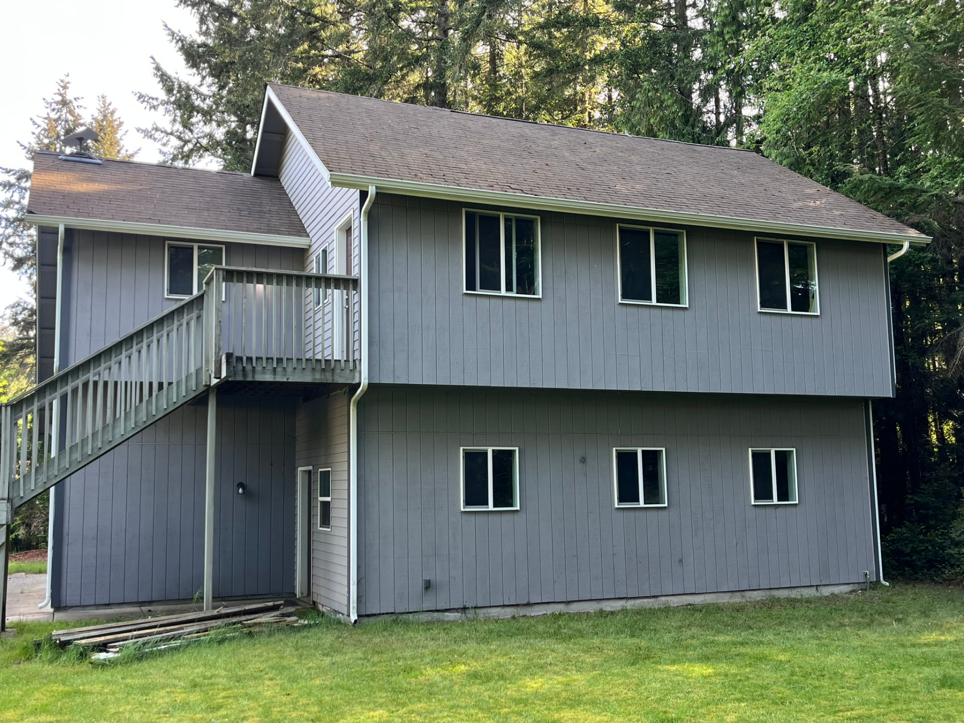 The same house roof after moss removal and treatment, shingles clean